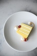 © Anna Petrow - Yellow sponge cake slice with raspberries and cream