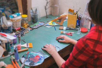 detail of young woman in messy studio