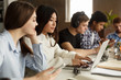 © Prostock-studio - Student girls networking on laptop in library