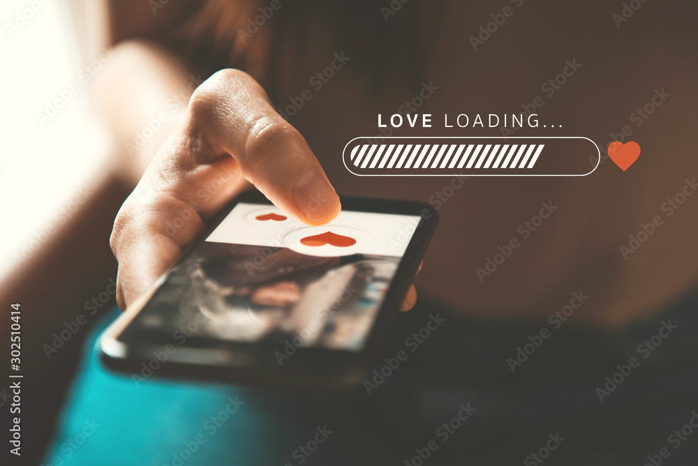 Love loading progress, Finger of woman pushing heart icon on screen in mobile smartphone application. Online dating app, valentine's day concept. - obrazy, fototapety, plakaty 