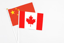 Canada And China Stick Flags On White Background. High Quality Fabric, Miniature National Flag. Peaceful Global Concept.White Floor For Copy Space.