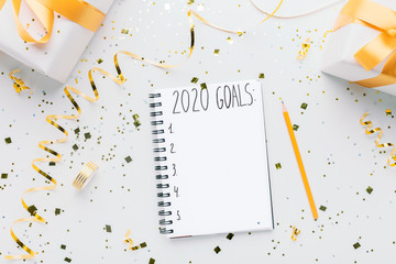 Wall Mural - Notebook with 2020 goals and gift boxes on white