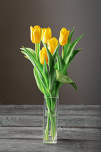 Bouquet Of Yellow Tulips In A Transparent Glass Vase.