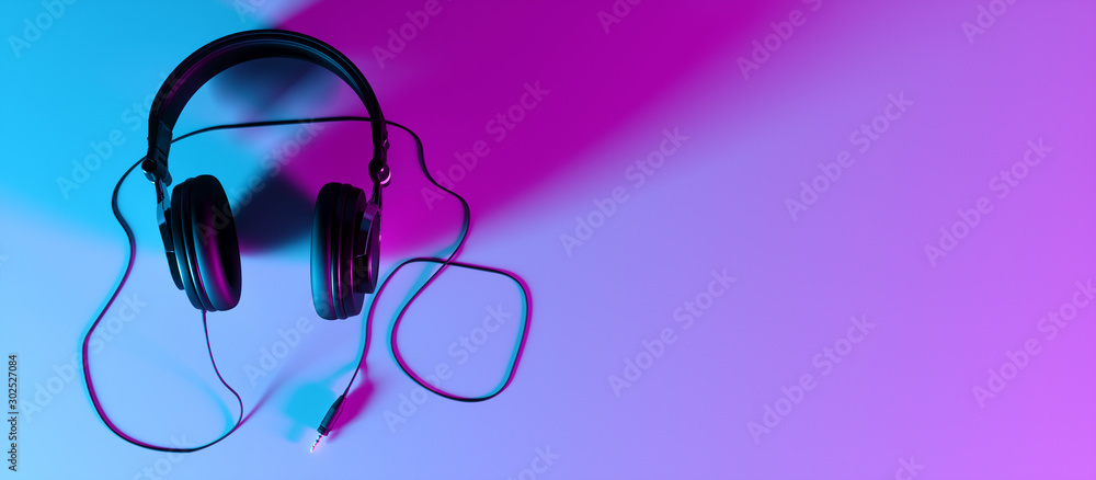 headphones on a black background close-up in neon light - obrazy, fototapety, plakaty 