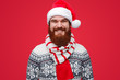 © kegfire - Happy male in Santa hat and striped scarf