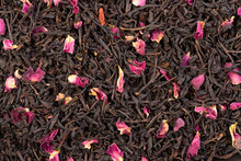 Earl Grey Black Dry Tea Leaves With Rose Petals Background