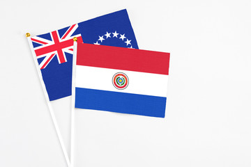 Paraguay and Cook Islands stick flags on white background. High quality fabric, miniature national flag. Peaceful global concept.White floor for copy space.