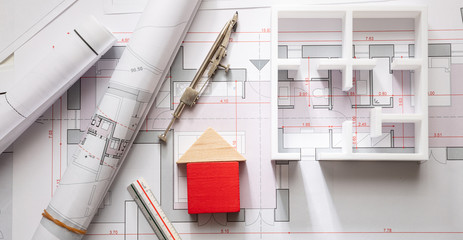 Construction concept. Residential building drawings and architectural model