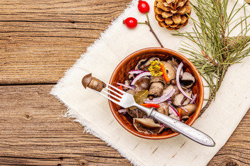 Wall Mural - Pickled (fermented) mushrooms. Traditional New Year (Christmas) snack. Festive table cutlery setting