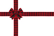 © Jenifoto - Red and black buffalo plaid Christmas gift bow and ribbon arranged as wrapped gift box isolated on a white background