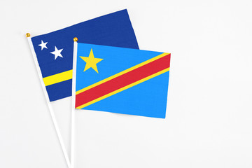 Congo and Curacao stick flags on white background. High quality fabric, miniature national flag. Peaceful global concept.White floor for copy space.