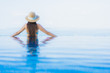 © siraphol - Portrait beautiful young asian women happy smile relax outdoor swimming pool in resort