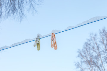 clothespins with snow on a clothesline