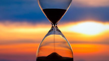 Hourglass On The Background Of A Sunset. The Value Of Time In Life. An Eternity.