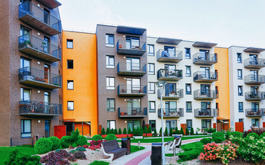 Canvas Print - Modern residential apartment with flat building exterior with outdoor facilities. New luxury house and home complex and green yard. City Real estate property and condo architecture. Empty background