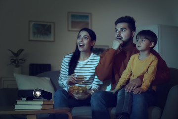 Poster - Emotional family watching movie at home, focus on video projector