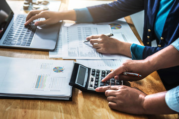 Fototapete - Businesswoman meeting time. accountant managers  working with new startup project. using calculator and laptop in office