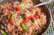 Jamaican and Mexican healthy vegetarian dish - rice with beans and vegetables and hot peppers and spring onions in a bowl, close-up
