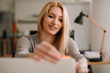 © JustLife - Close up of businesswoman putting sticky notes on laptop.