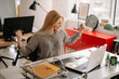 © JustLife - Young businesswoman in the office. Beautiful businesswoman celebrating new achievement.