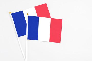 France and France stick flags on white background. High quality fabric, miniature national flag. Peaceful global concept.White floor for copy space.