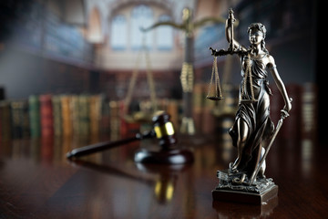 Wall Mural - Law and justice theme.  Gavel of  the judge, Themis statue and the scale on court library background.