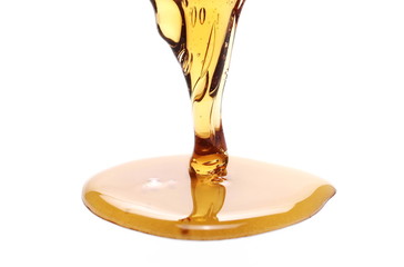 Honey pouring, dripping isolated on white background