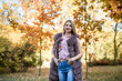 © RomanR - Fashion woman. Smiling girl in fur coat posin in autumn park with trees and ivy