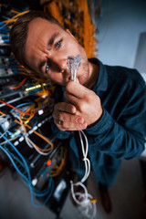 Wall Mural - Close up view of funny man with internet wires in server room