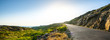 canvas print picture - Empty long mountain road to the horizon on a sunny summer day at bright sunset