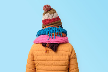 Wall Mural - Handsome caucasian funny man hiding face in several hats and scarfs.