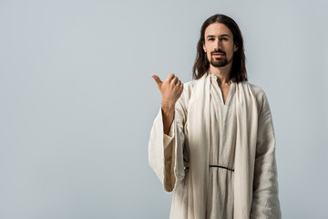 Wall Mural - happy bearded man in jesus robe showing thumb up isolated on grey