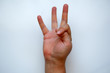 © Ridvan - White Male Hand Shows Three on White Background