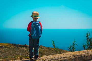 little boy travel in mountains at sea, kid hiking in nature, vacation in Malta