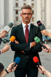© Svitlana - Seeking the truth. Journalists trying to conduct interview of businessman. Journalism industry, live streaming concept.