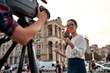 © Svitlana - More news. More often. TV reporter presenting the news outdoors. Journalism industry, live streaming concept.