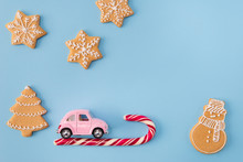 High Angle View Photo Of X-mas Greeting Postcard Small Retro Pink Car Driving Home On Candy Stick Newyear Night Decor Cookies Figures Fir Tree Stars Isolated Blue Color Background