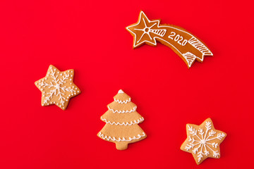 Wall Mural - Top above high angle view photo of composition gingerbread cookies christmas tree star falling with 202o text prepared for x-mas celebration party lie isolated over red color background