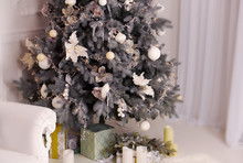  Magically Decorated Christmas Tree In Sparkling Light Toys And Gifts Under The Tree In A Bright Room.