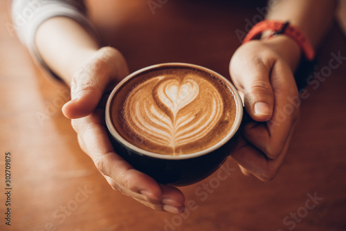 Close up Cup of coffee latte in coffee shop Poster Mural XXL