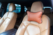 The seats in the car are made of brown leather with pillows for the neck and rest during long trips and travels.