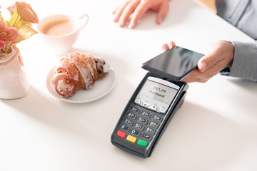 Wall Mural - Man using smart phone to pay in restaurant