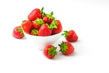 Red ripe strawberry in the white bowl, light background