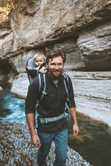 father and baby in backpack carrier traveling hiking together family adventure lifestyle outdoor vac