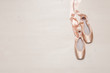 Ballet pointe shoes isolated on wooden background