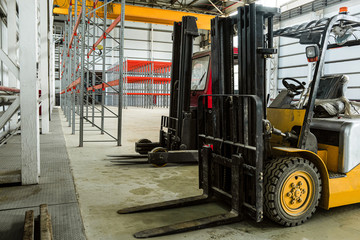 Forklift trucks in a industrial warehouse building