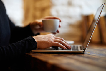 Wall Mural - Man working with laptop in cafe...