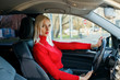 © kosta57 - young beautiful girl in a red sweater driving a car
