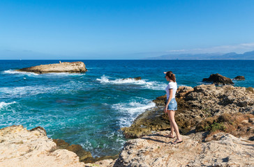 Young girl in sea coastline on Crete near Hersonissos