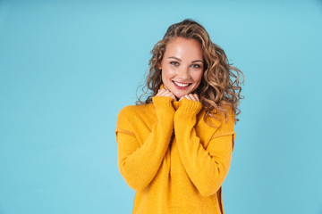 Wall Mural - Cheerful lovely young girl wearing sweater standing